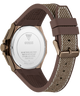 Rear view of a Guess watch with a brown textured silicone strap and a rose gold case, showing the stainless steel case back engraved with the Guess logo.