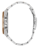 Close-up side profile of a wristwatch with a polished silver-tone metal link bracelet and a small gold-toned accent visible on the case, shown on a plain white background.