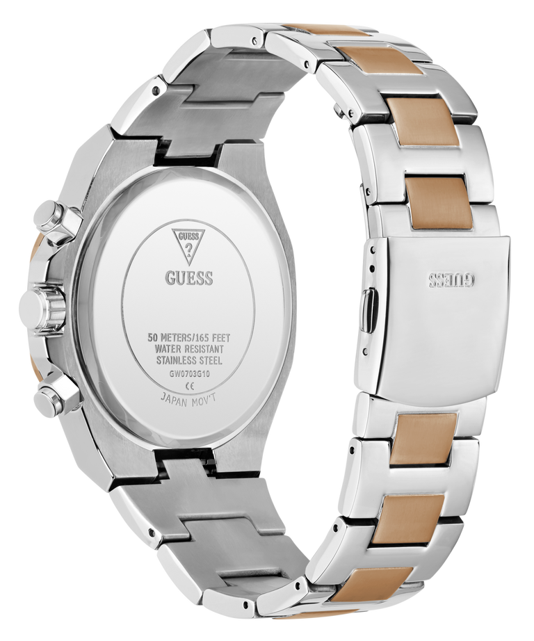 The back view of a stainless steel GUESS watch with a two-tone link bracelet featuring silver and gold-colored inserts, on a solid white background.