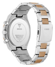 The back view of a stainless steel GUESS watch with a two-tone link bracelet featuring silver and gold-colored inserts, on a solid white background.