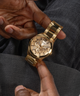 GUESS Mens Gold Tone Multi-function Watch lifestyle hand holding watch