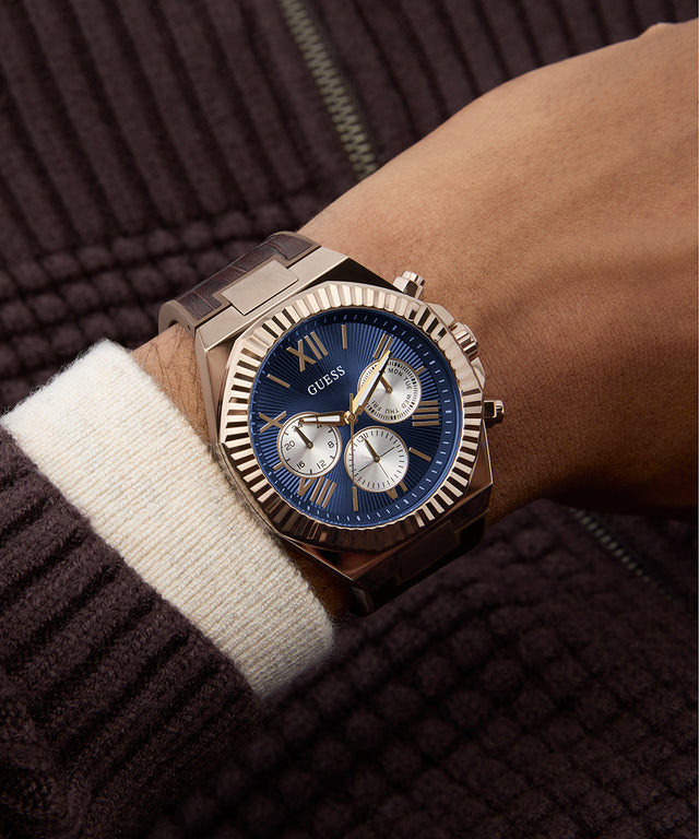 GUESS Mens Brown Coffee Multi-function Watch on a person's wrist with a dark background