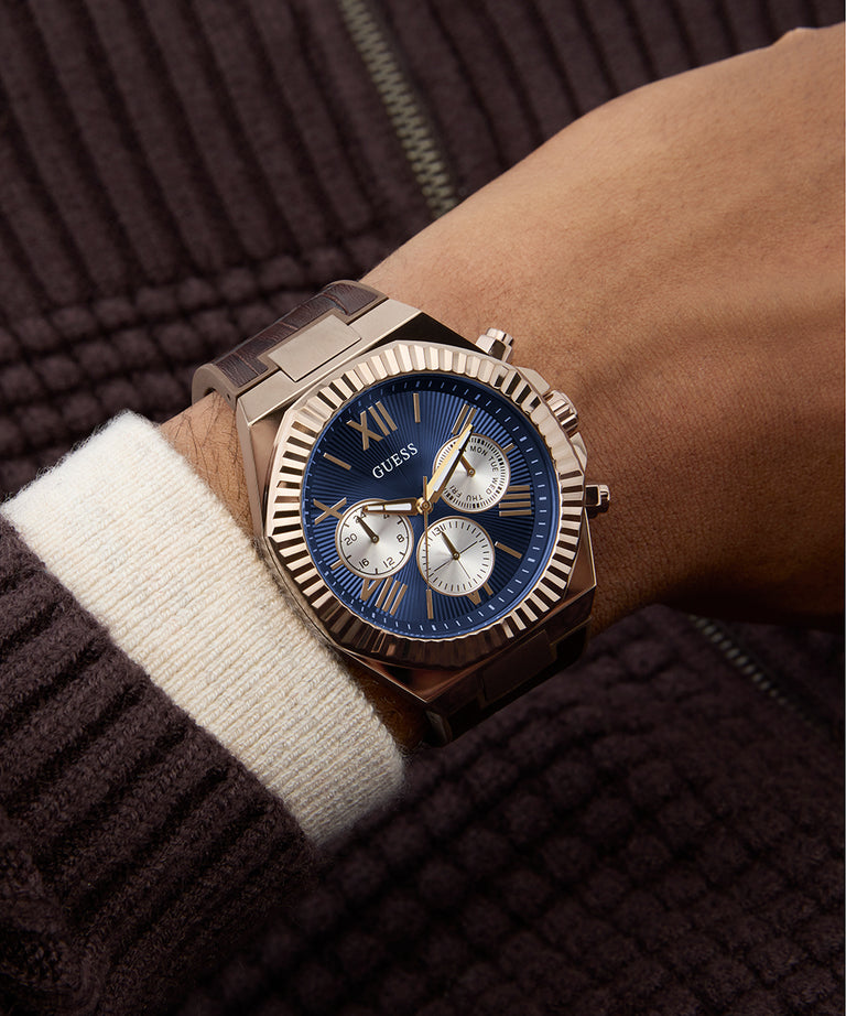 GUESS Mens Brown Coffee Multi-function Watch on a person's wrist with a dark background