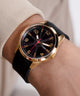 GW0805G2 GUESS Mens Black Gold Tone Analog Watch watch on arm