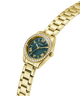 Gold watch with a teal face on a white background lifestyle