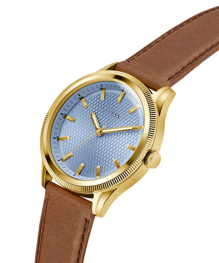 Watch with gold case, blue dial, and brown leather strap on a white background lifestyle