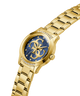 Gold watch with blue face and visible brand logo on a white background lifestyle