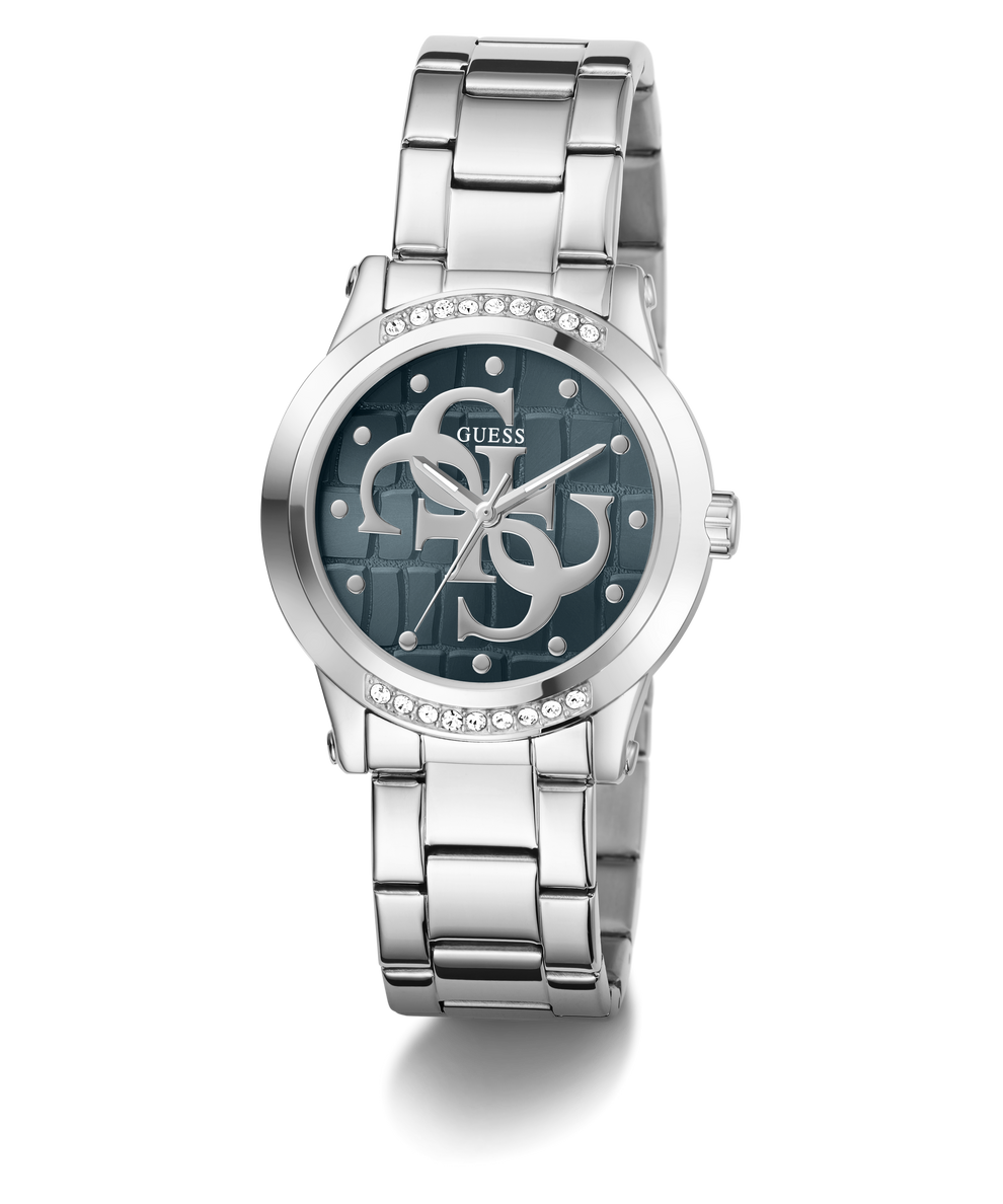 A Guess women's analog watch with a silver stainless steel link bracelet, a round bezel set with clear crystals, and a dark blue dial featuring the brand's interlocking G logo.