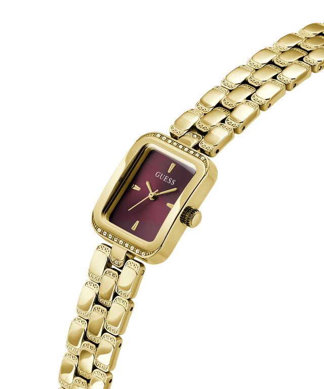A gold-tone Guess watch with a rectangular purple dial and a matching gold-tone link bracelet, shown on a plain white background. lifestyle