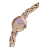 A rose gold Guess watch with a glittery pink and gold dial and a matching rose gold link bracelet embellished with rhinestones, shown on a plain white background. lifestyle