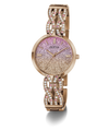 A Guess women's watch with a rose gold-tone metal bracelet and case, featuring a glittery pink-to-gold gradient dial and crystal-studded decorative links on the bracelet.
