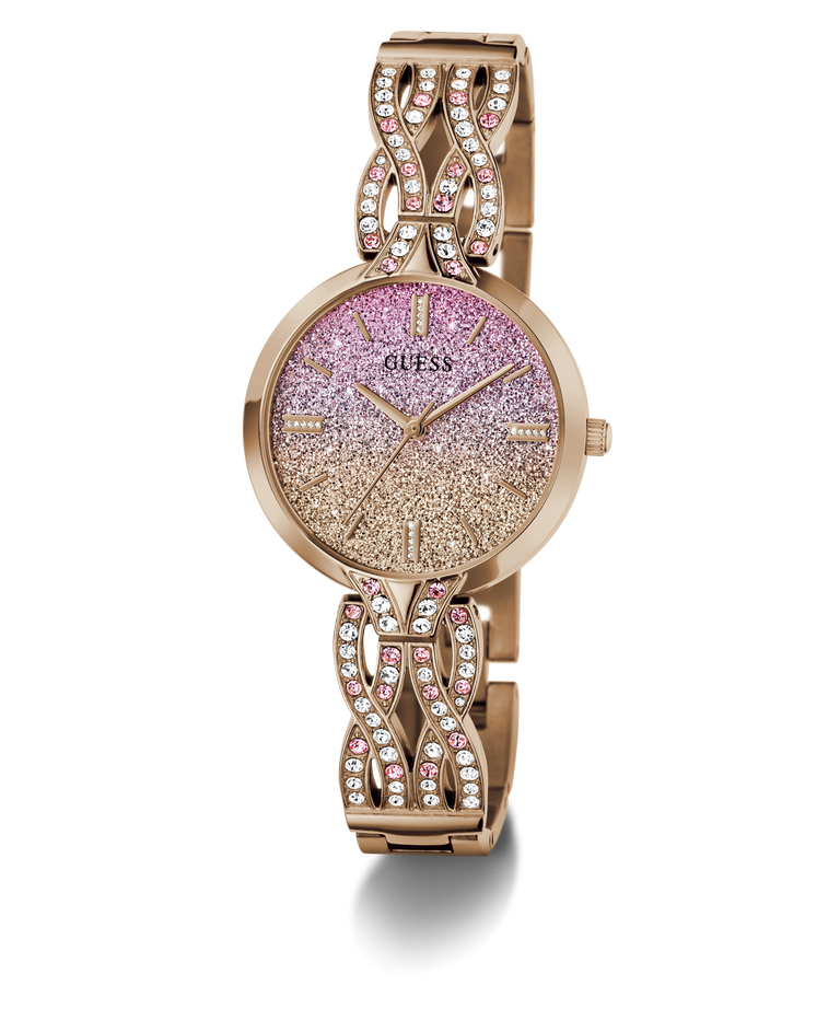 A Guess women's watch with a rose gold-tone metal bracelet and case, featuring a glittery pink-to-gold gradient dial and crystal-studded decorative links on the bracelet.