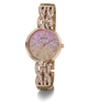 A Guess women's watch with a rose gold-tone metal bracelet and case, featuring a glittery pink-to-gold gradient dial and crystal-studded decorative links on the bracelet.