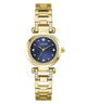 A gold-tone Guess watch with a blue sunburst dial and crystal-studded bezel, shown on a plain white background.