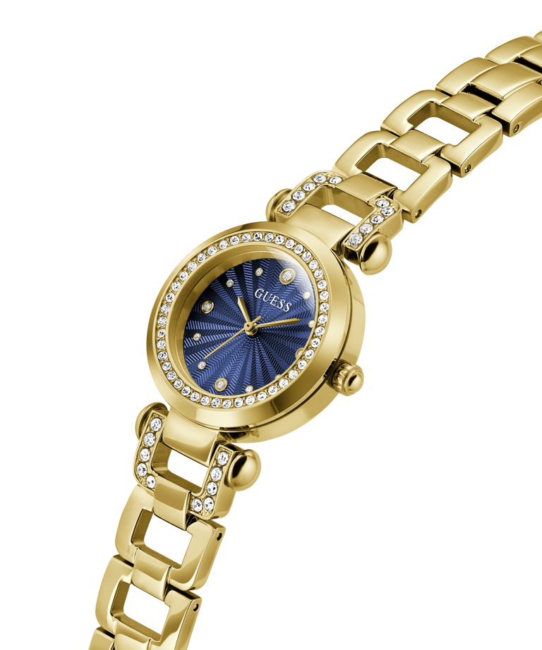 Gold-tone Guess women's watch with a blue sunburst dial, crystal-encrusted bezel and link details, shown on a plain white background. lifestyle