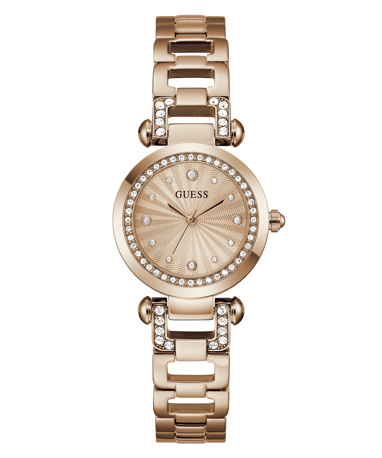 A GUESS women's watch featuring a rose gold-tone metal case and link bracelet, embellished with clear crystals around the bezel and bracelet links. The dial is a matching rose gold color with a sunburst pattern and crystal hour markers.
