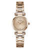 A GUESS women's watch featuring a rose gold-tone metal case and link bracelet, embellished with clear crystals around the bezel and bracelet links. The dial is a matching rose gold color with a sunburst pattern and crystal hour markers.