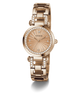 A rose gold Guess watch with a round dial, crystal-encrusted bezel, and matching crystal-accented link bracelet, shown on a clean white background.