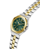 Two-tone watch with green face and gold accents on a clear background lifestyle