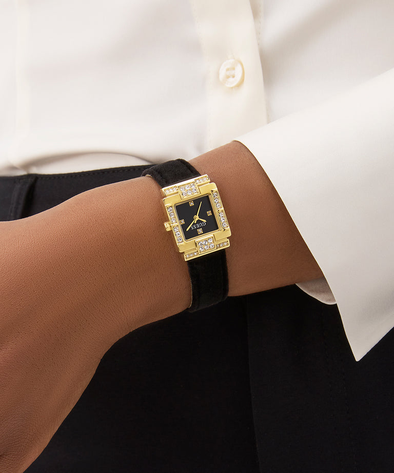 GUESS Ladies Black Gold Tone Analog Watch on model's wrist