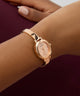 GUESS Ladies Rose Gold Tone Analog Watch on a wrist with a blurred background