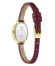 The back view of a Guess watch with a gold-tone case and a burgundy leather strap, showing the brand name 'GUESS' printed on the inner strap and the stainless steel case back.