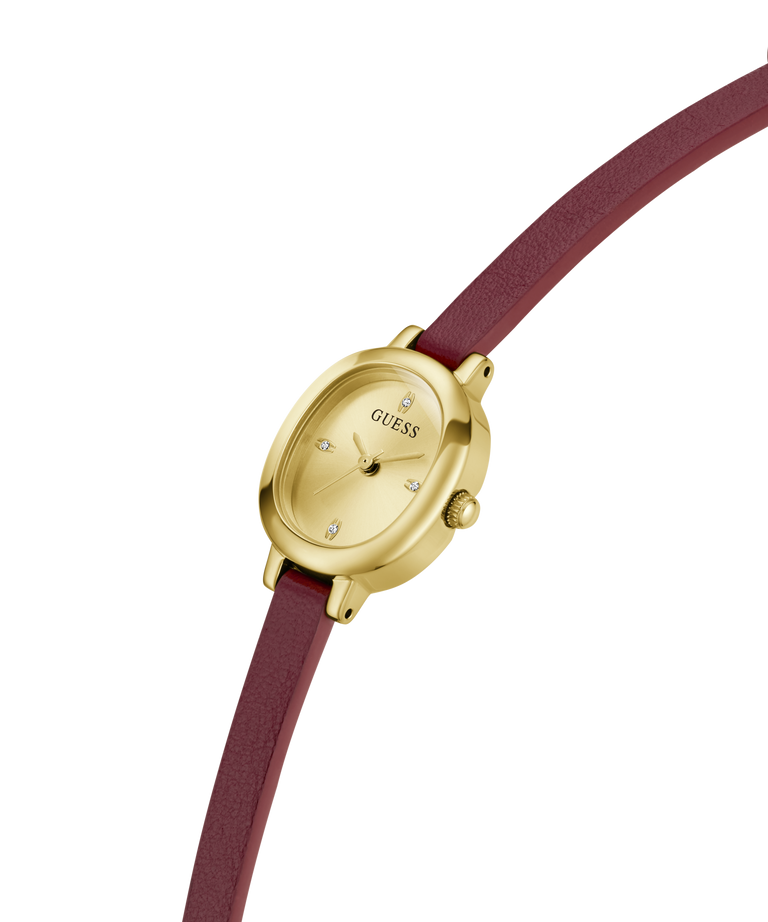 A GUESS women's watch featuring an oval gold-tone case, a champagne dial with crystal hour markers, and a burgundy leather strap, shown on a plain white background. lifestyle