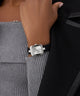 Person wearing a black watch with a gray sleeve and black jacket GW0926L1