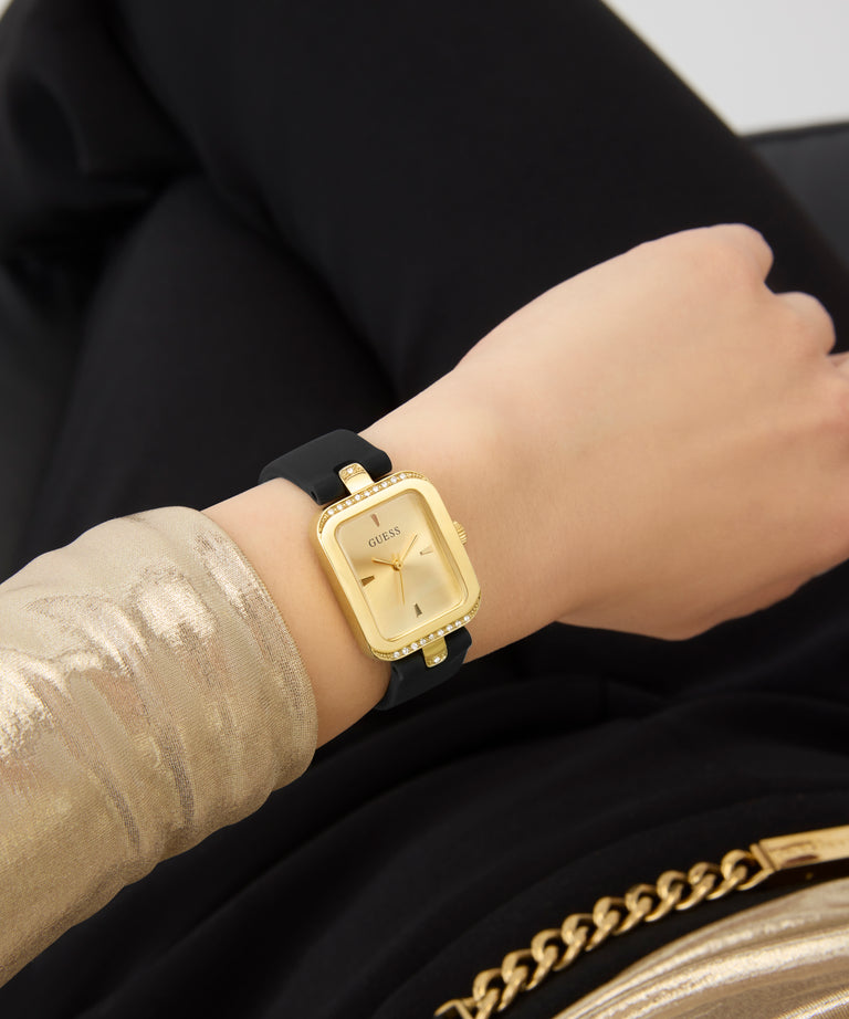 Gold watch with black strap on a wrist, blurred background GW0926L2