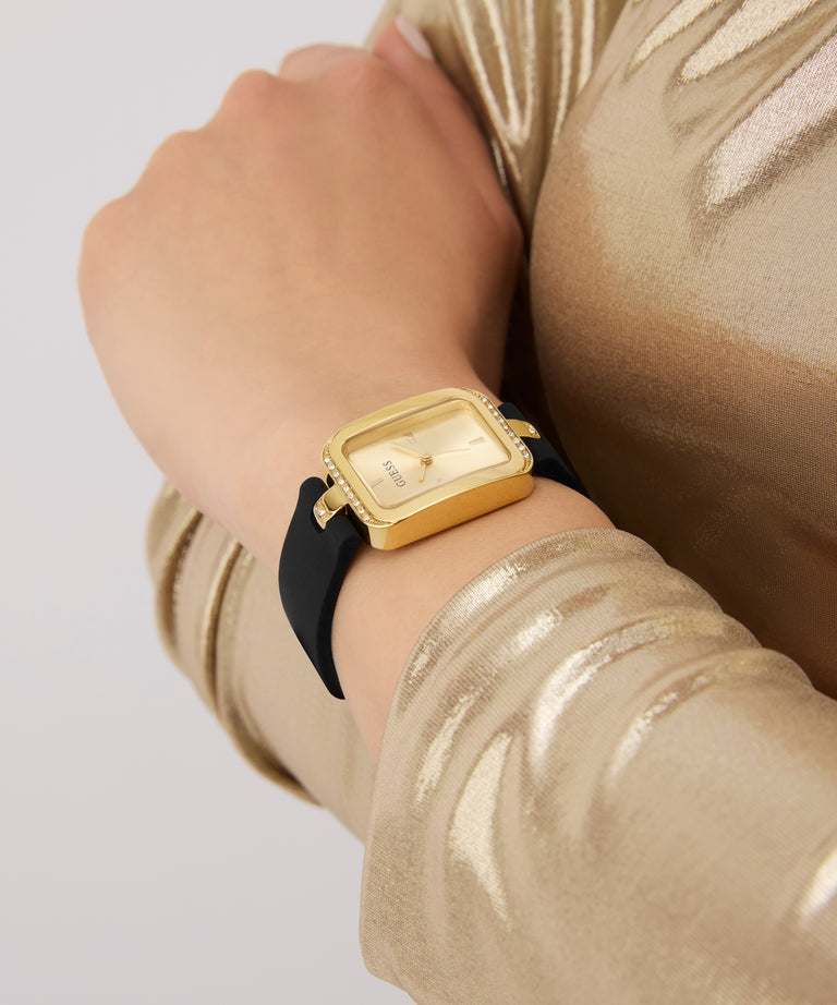 Gold watch on a wrist with a gold sleeve against a light gray background GW0926L2