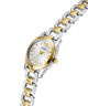 Two-tone silver and gold watch with a white face on a white background lifestyle