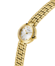 Gold watch with a white face on a white background lifestyle
