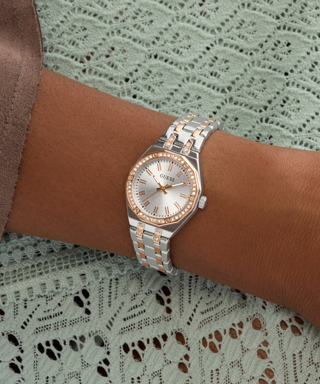 Silver and rose gold watch on a wrist with a lace background