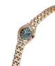 Gold watch with a blue face on a white background lifestyle