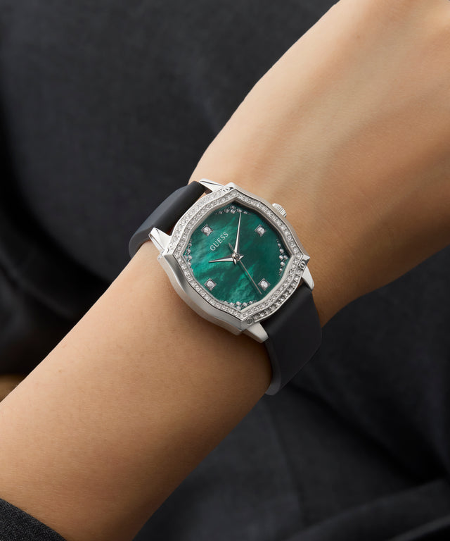 GUESS Ladies Black Silver Tone Analog Watch with green face and diamond accents on a wrist against a dark background