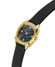 Gold watch with black strap and diamond-like accents on a white background lifestyle