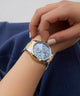 GUESS Ladies 2-Tone Multi-function Watch on a person's wrist with a neutral background