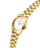 Gold watch with a white face on a white background lifestyle