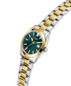 GUESS Ladies 2-Tone Date Watch with green dial on a white background lifestyle