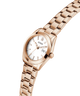 Rose gold watch with a white face on a white background lifestyle