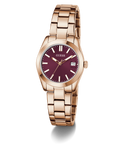 GUESS Ladies Rose Gold Tone Date Watch with a deep red face on a white background