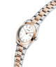 Two-tone silver and rose gold GUESS Ladies 2-Tone Date Watch with white face on a white background lifestyle