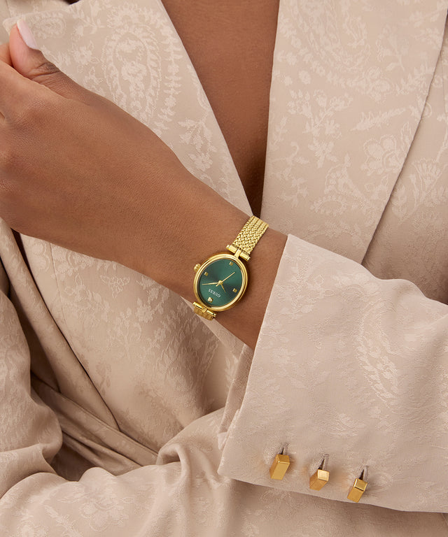 GUESS Ladies Gold Tone Analog Watch on a wrist with a neutral background