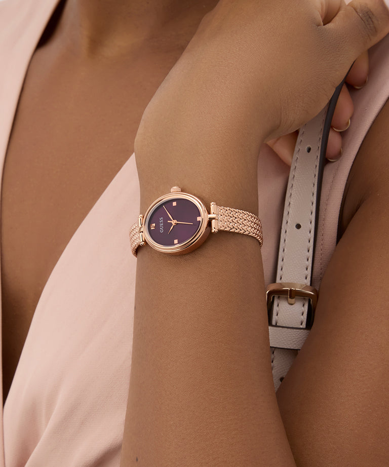 GUESS Ladies Rose Gold Tone Analog Watch on a wrist with a neutral background