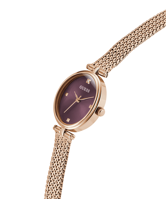 GUESS Ladies Rose Gold Tone Analog Watch with a burgundy face on a white background lifestyle