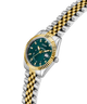 Two-tone silver and gold watch with a green dial on a white background lifestyle