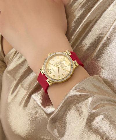 Gold GUESS Ladies Limited Edition Lunar New Year Red Gold Tone Analog Watch with a red strap on a person's wrist against a gold background