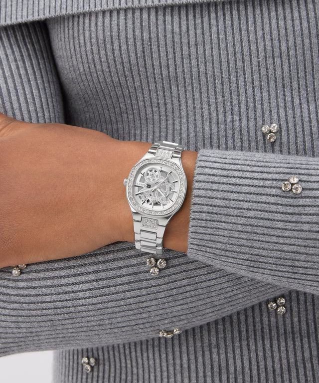 GUESS Ladies Silver Tone Analog Watch on a wrist with a gray ribbed sweater