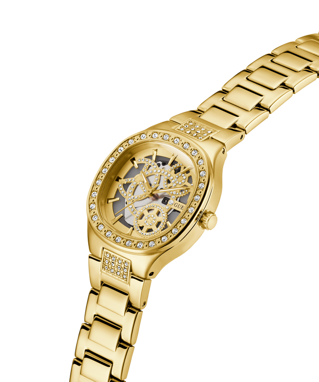 GUESS Ladies Gold Tone Analog Watch with a detailed face and diamond-studded band on a white background lifestyle