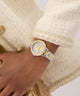 GUESS Ladies 2-Tone Analog Watch on a wrist with a textured beige jacket